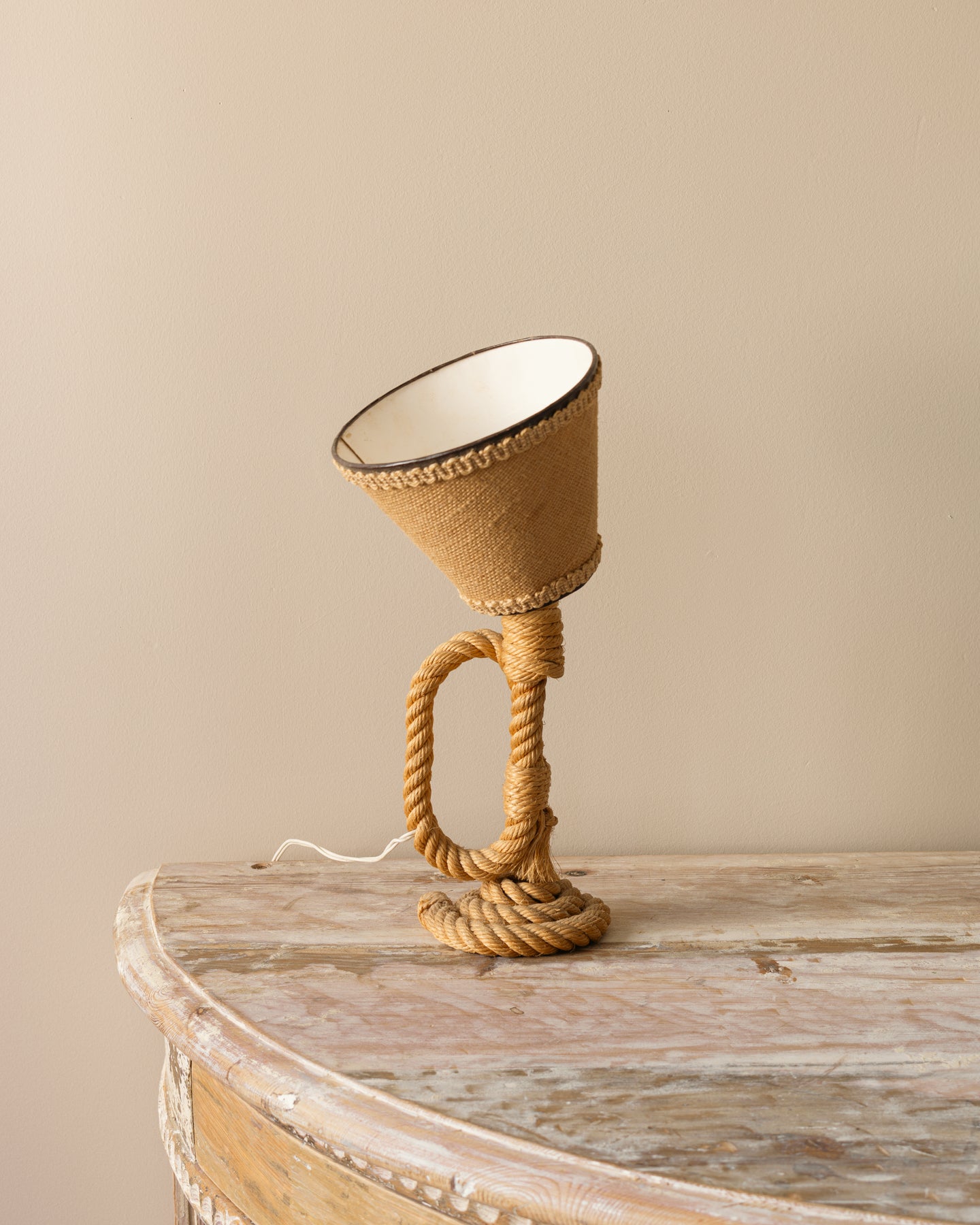 Small French rope table lamp with cylindrical coiled-rope body and tilted fabric shade; attributed to Audoux-Minet; 5.9″ diameter × 13″ high.