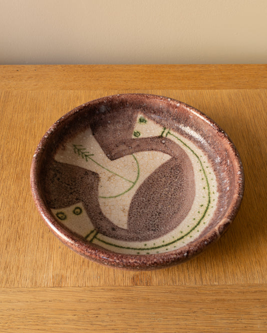 Image of Guido Gambone ceramic bowl showing figural decoration in green on a cream field with purple glaze, Italy 1950s.