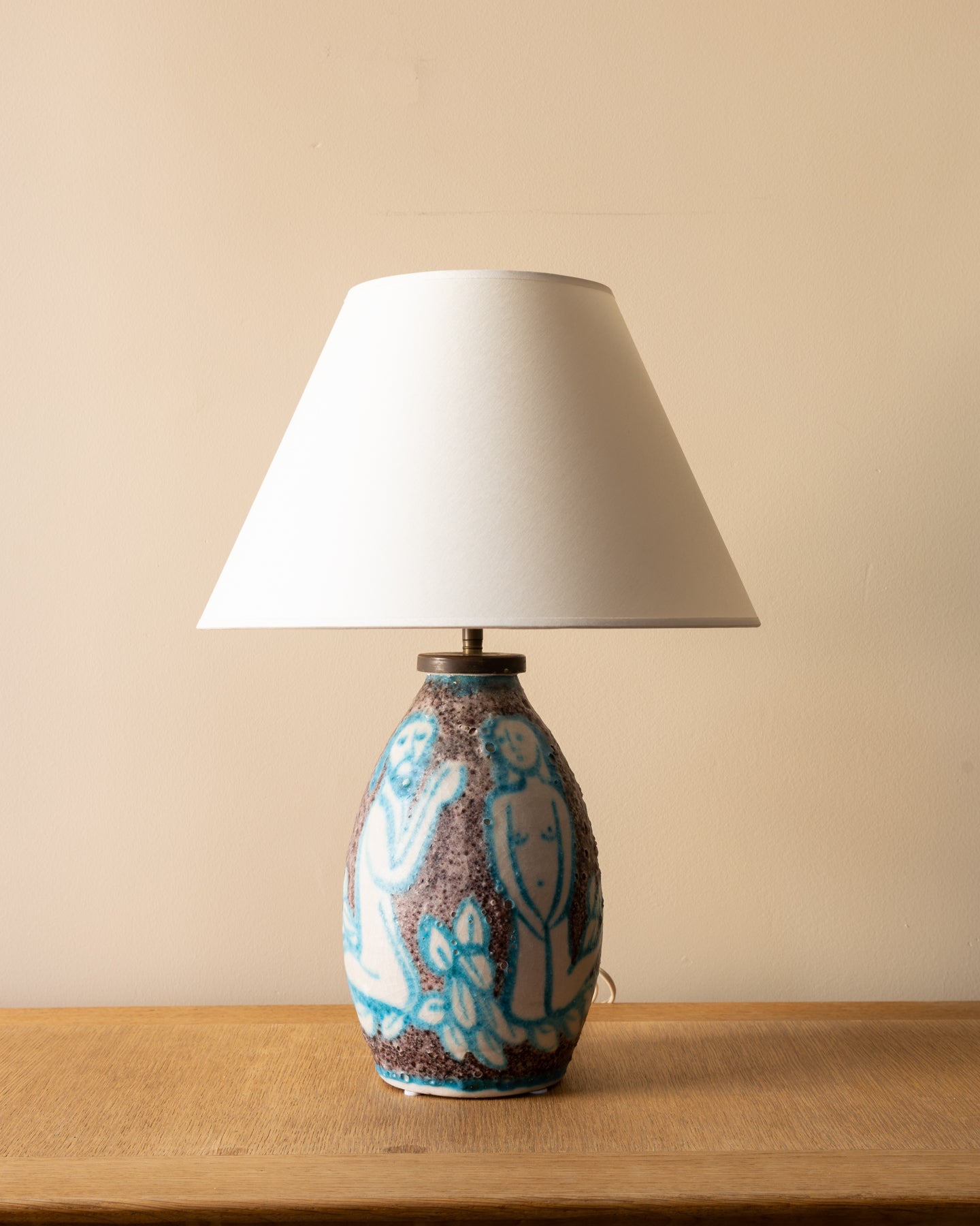 Image of the C.A.S. Vietri Adam and Eve glazed stoneware table lamp, Italy 1950 — showing turquoise figures on a speckled charcoal-gray ground.