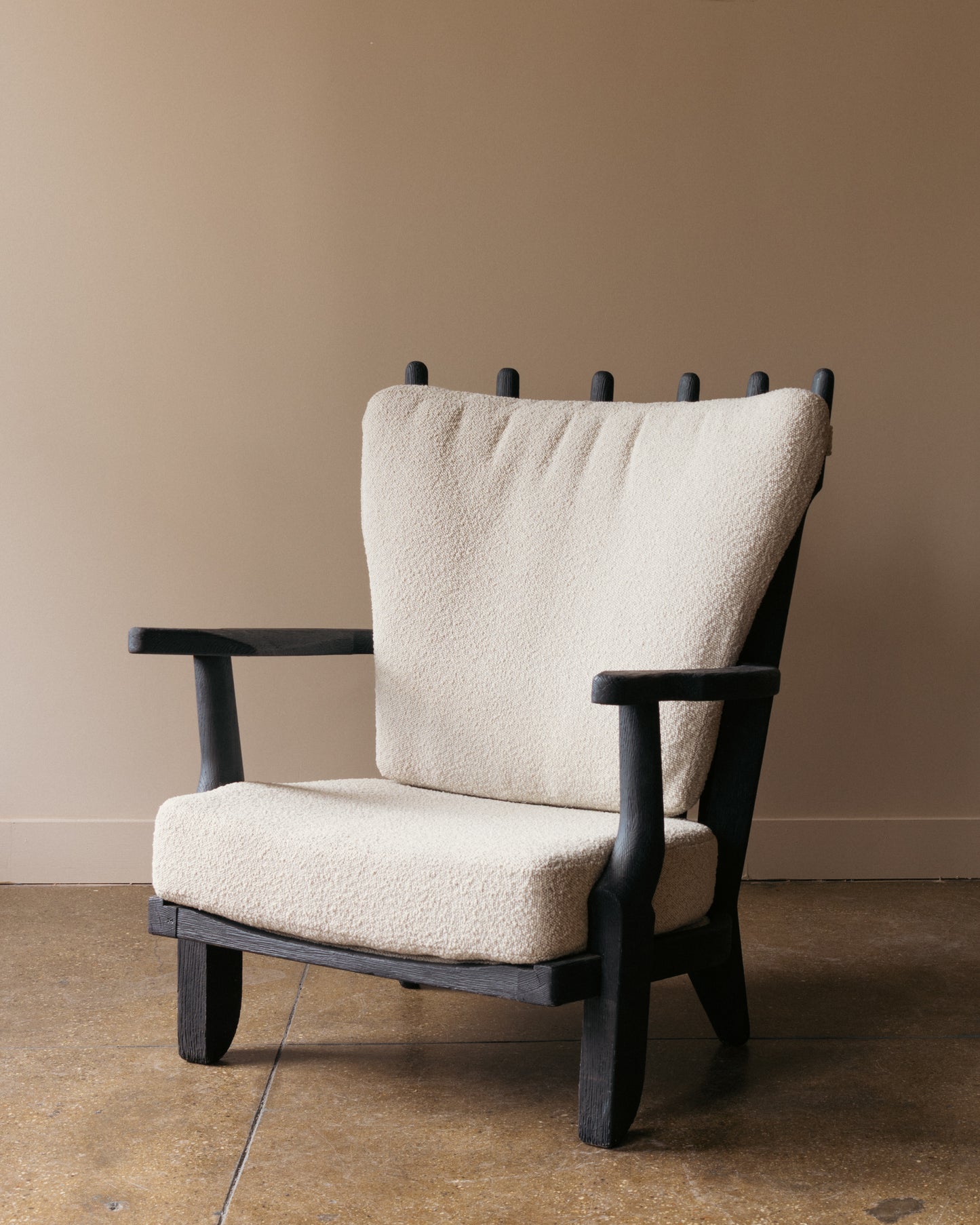 Ebonized Guillerme and Chambron Mid Repos lounge chair with sculpted oak back supports and bouclé cushions.